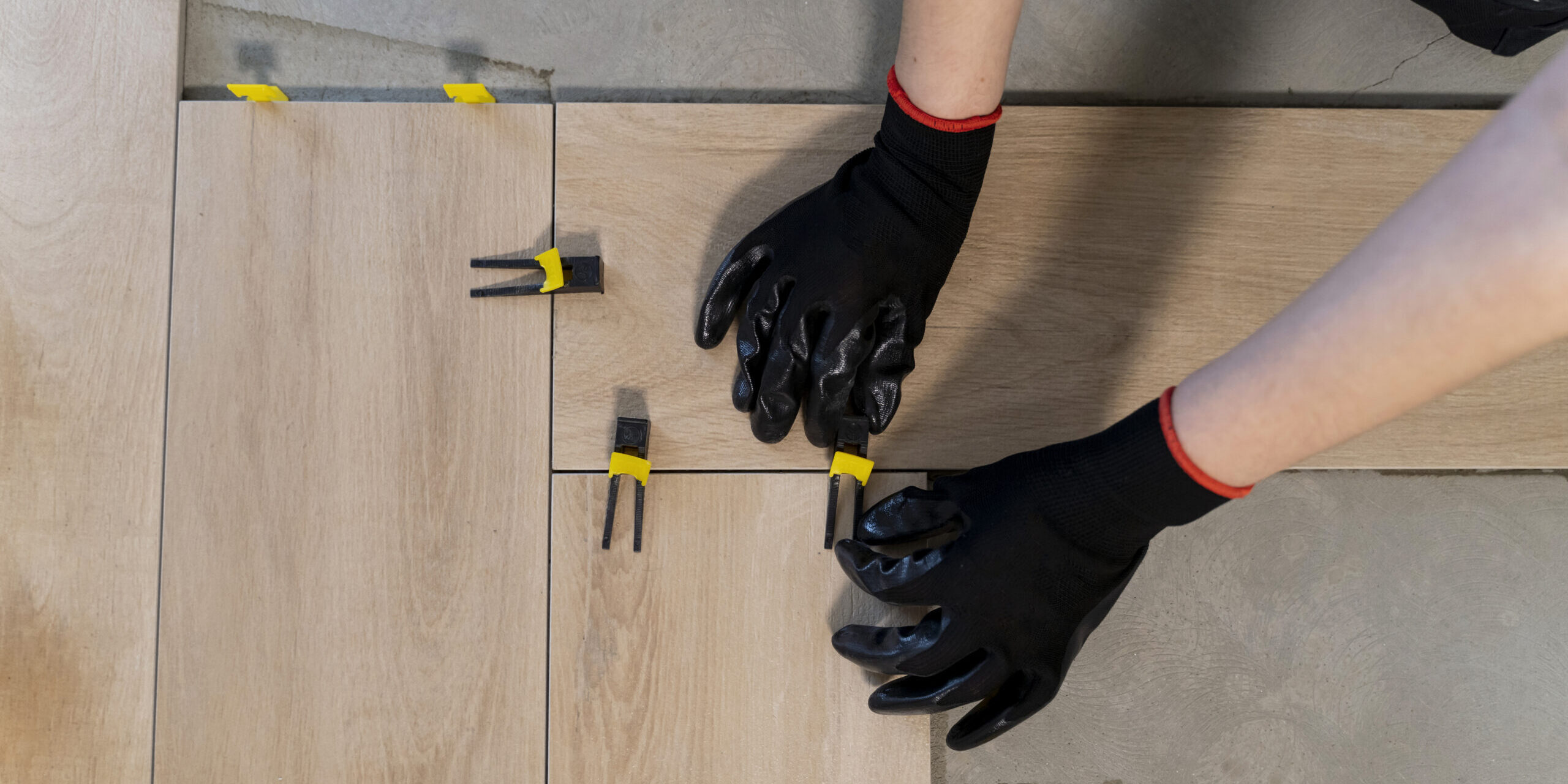 top-view-worker-tiling-floor
